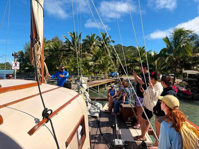 Guests aboard a vaka at the wharf in Rarotonga.
